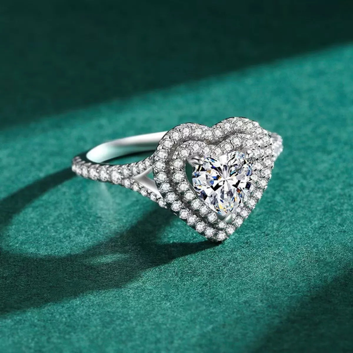 Close-up of wearing a diamond ring with a green background