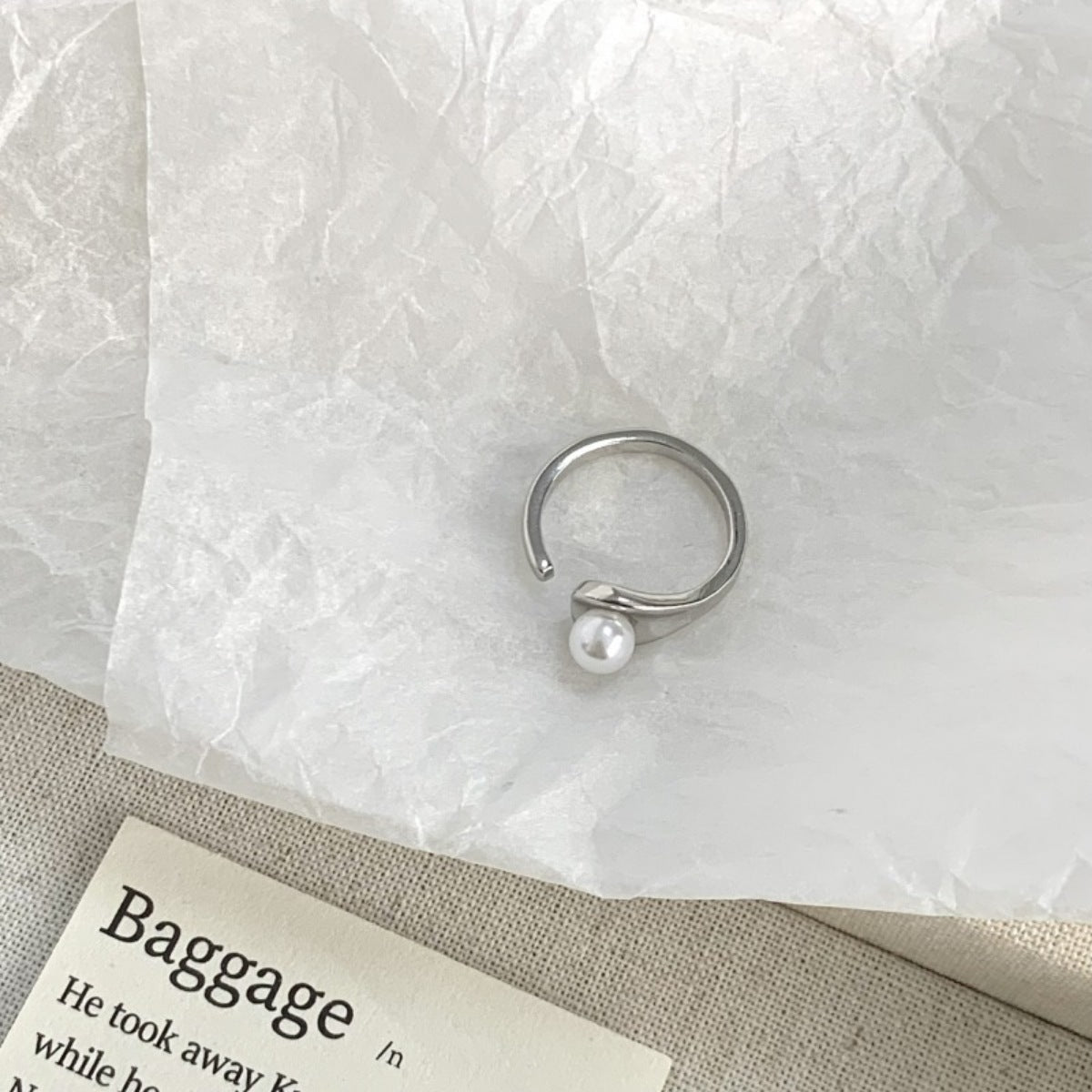 Close-up of luminous freshwater pearl set on 925 sterling silver open cuff ring