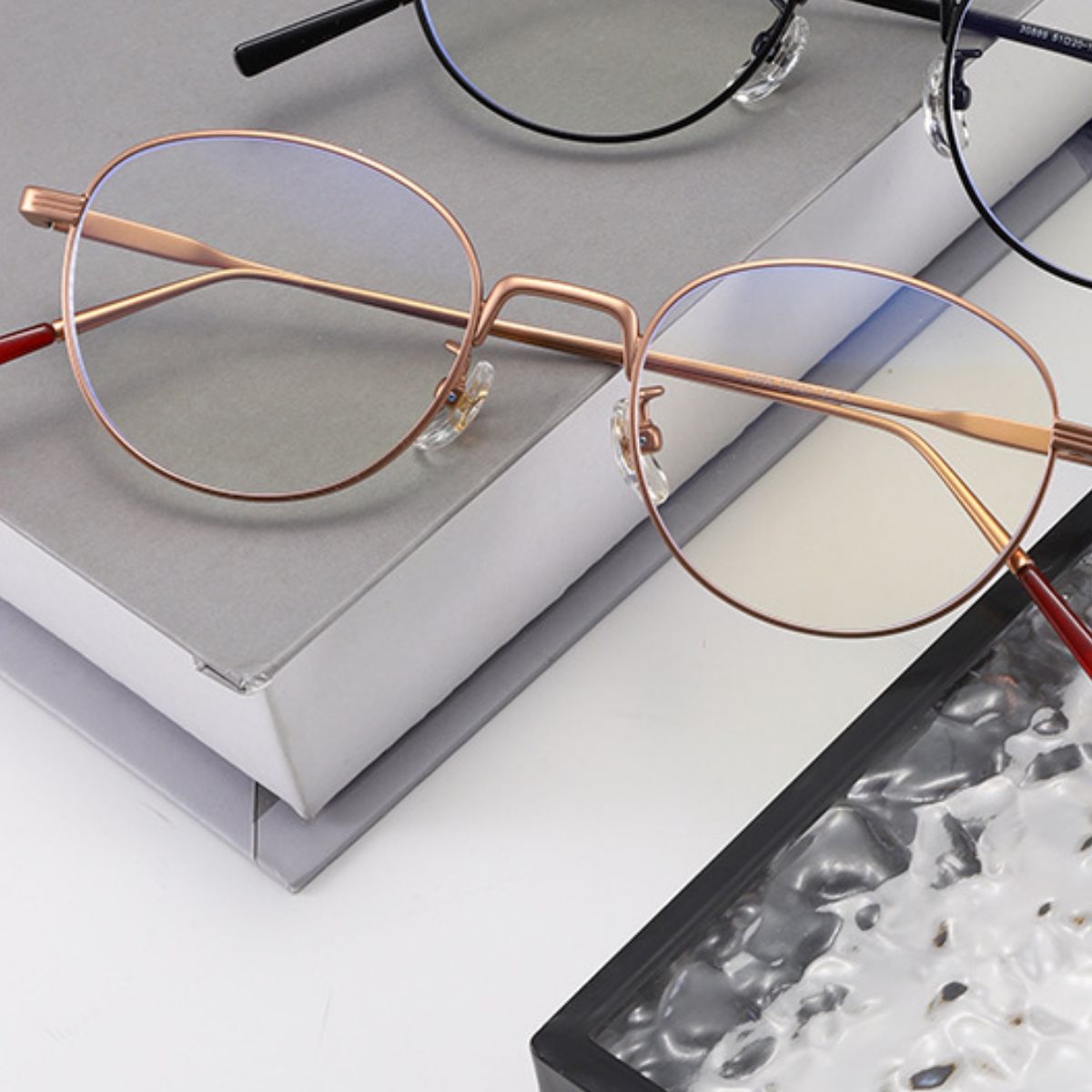 Side profile of lightweight metal round glasses showing thin temple design