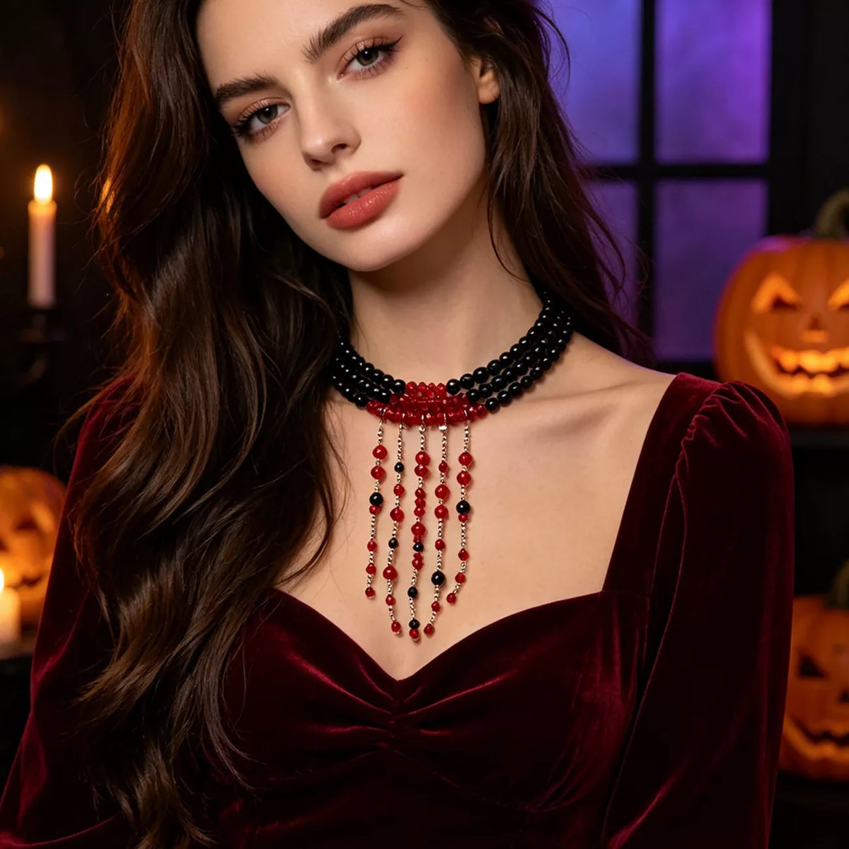 Black bead choker with red beaded fringe worn with a burgundy velvet dress