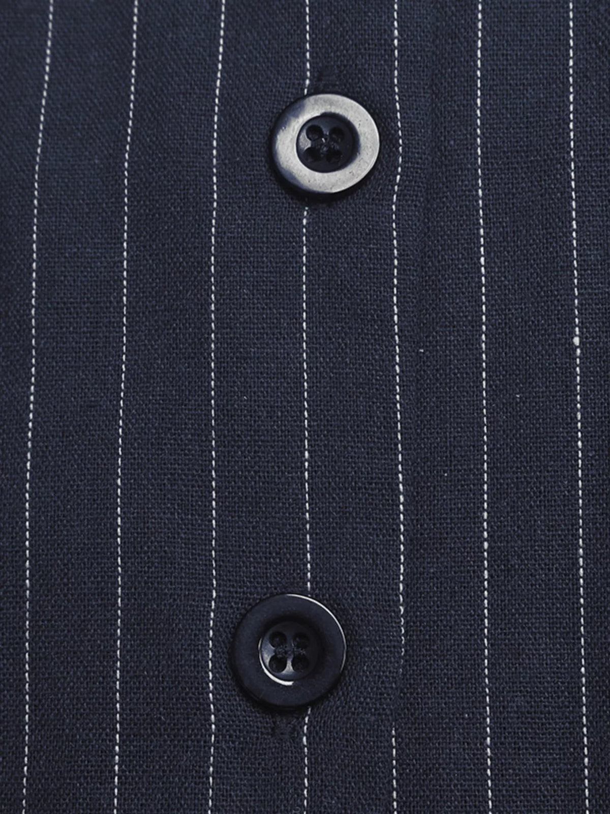 Close-up of a navy pinstripe fabric with two buttons.