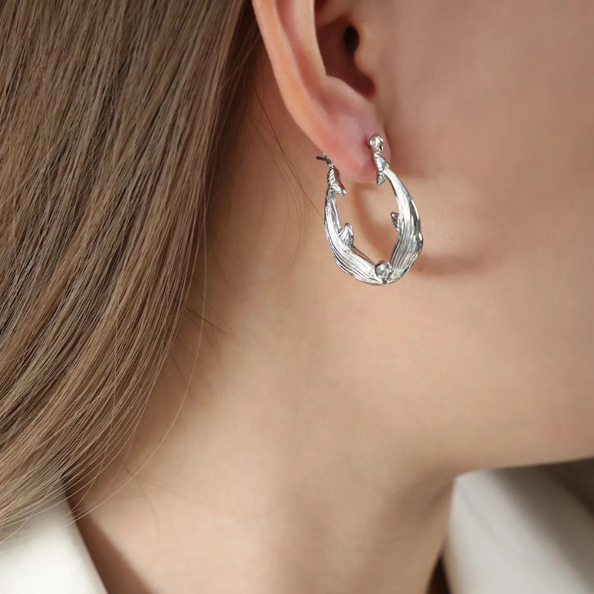 Kissing Dolphins Silver Plated Earrings On Models Earring Closeup Shot | Rebellious Gal Jewelry