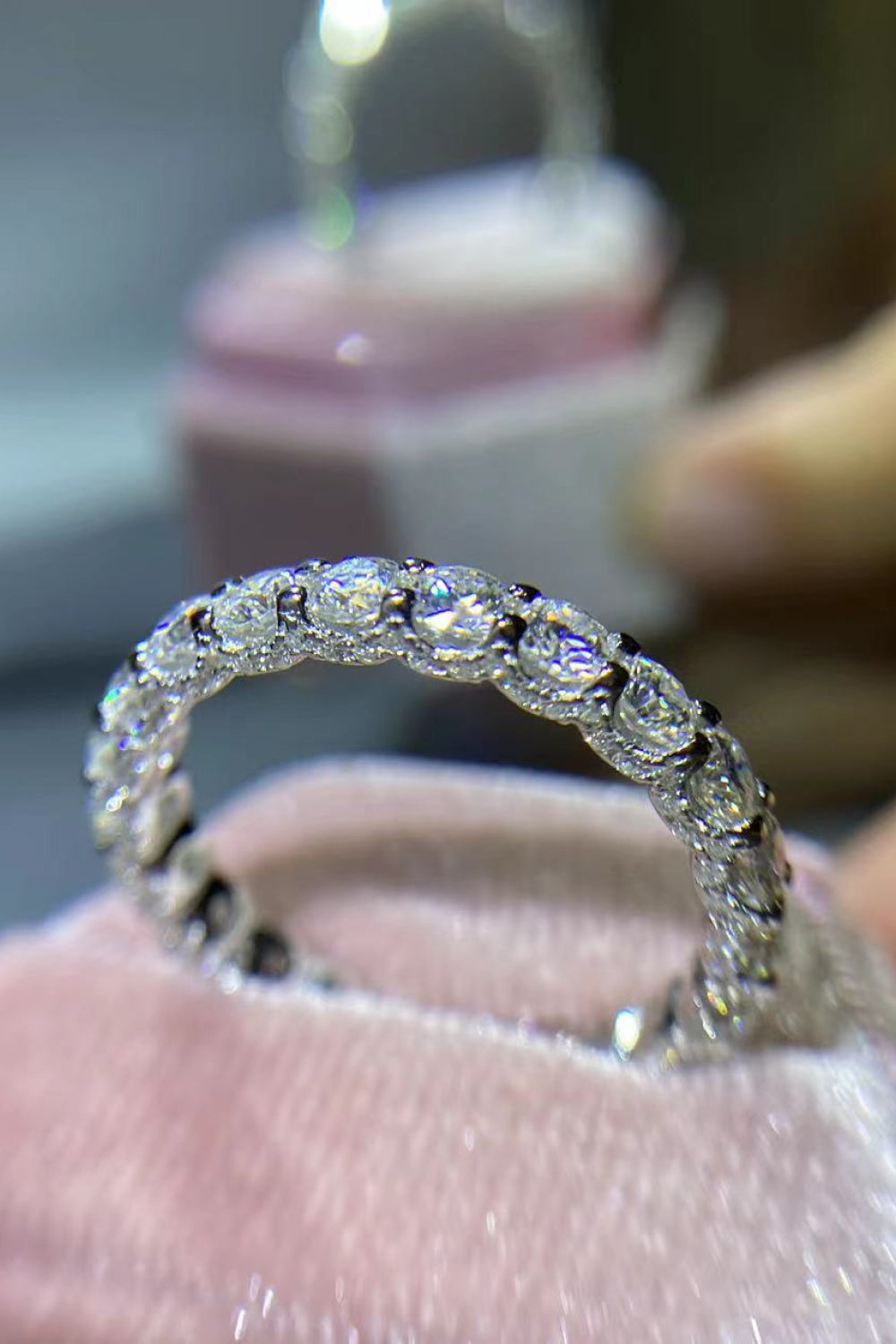 Close-up texture of platinum plating and secure moissanite setting