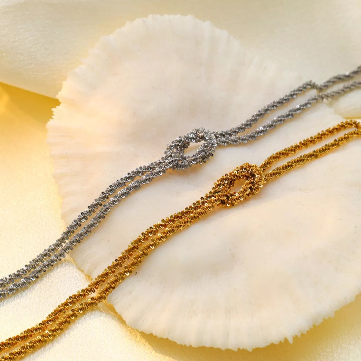 Edgy stainless steel bracelet for women, gold-plated twisted design close-up