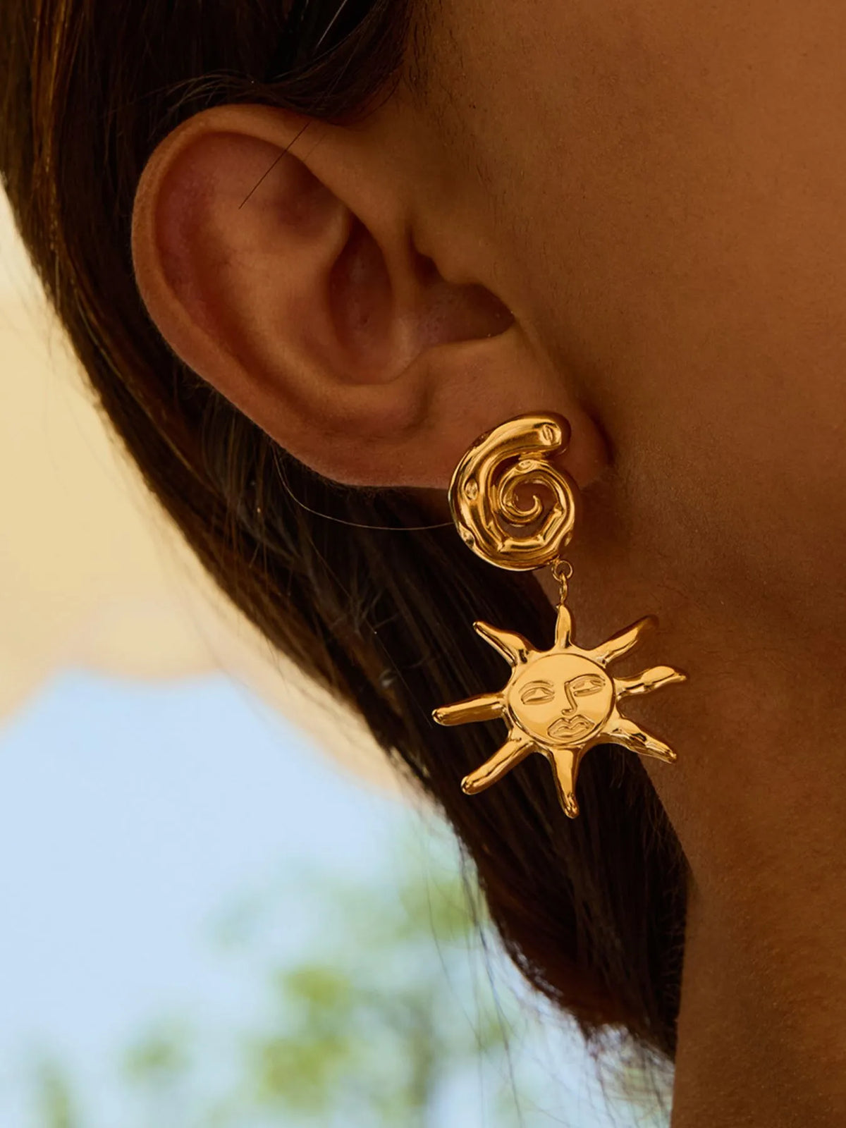 sun shine earrings on a model, close up look