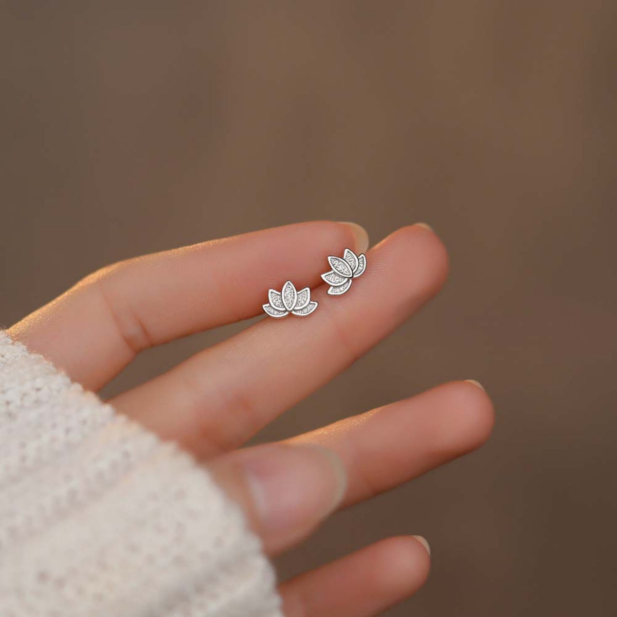 Pair of gold-plated sterling silver Lotus Stud Earrings on white background