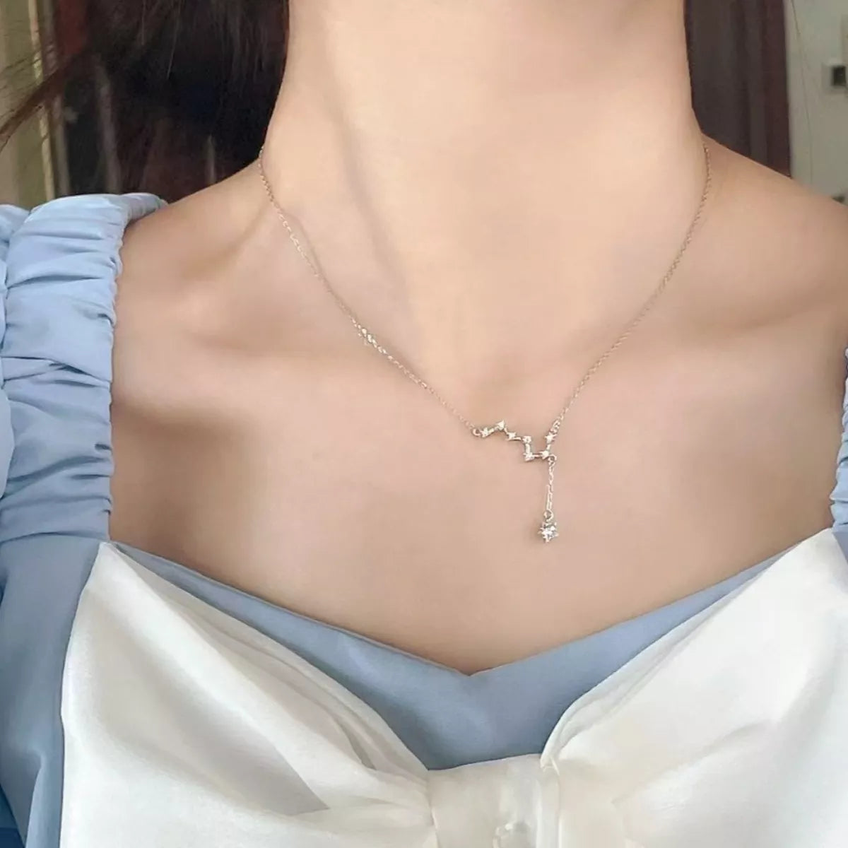 Dainty star pendant on sterling silver chain side profile detail
