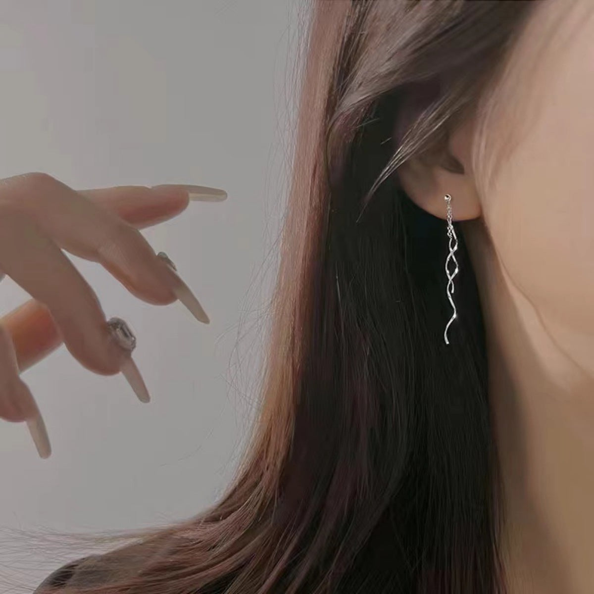 Close-up texture of smooth sterling silver curves and secure hooks