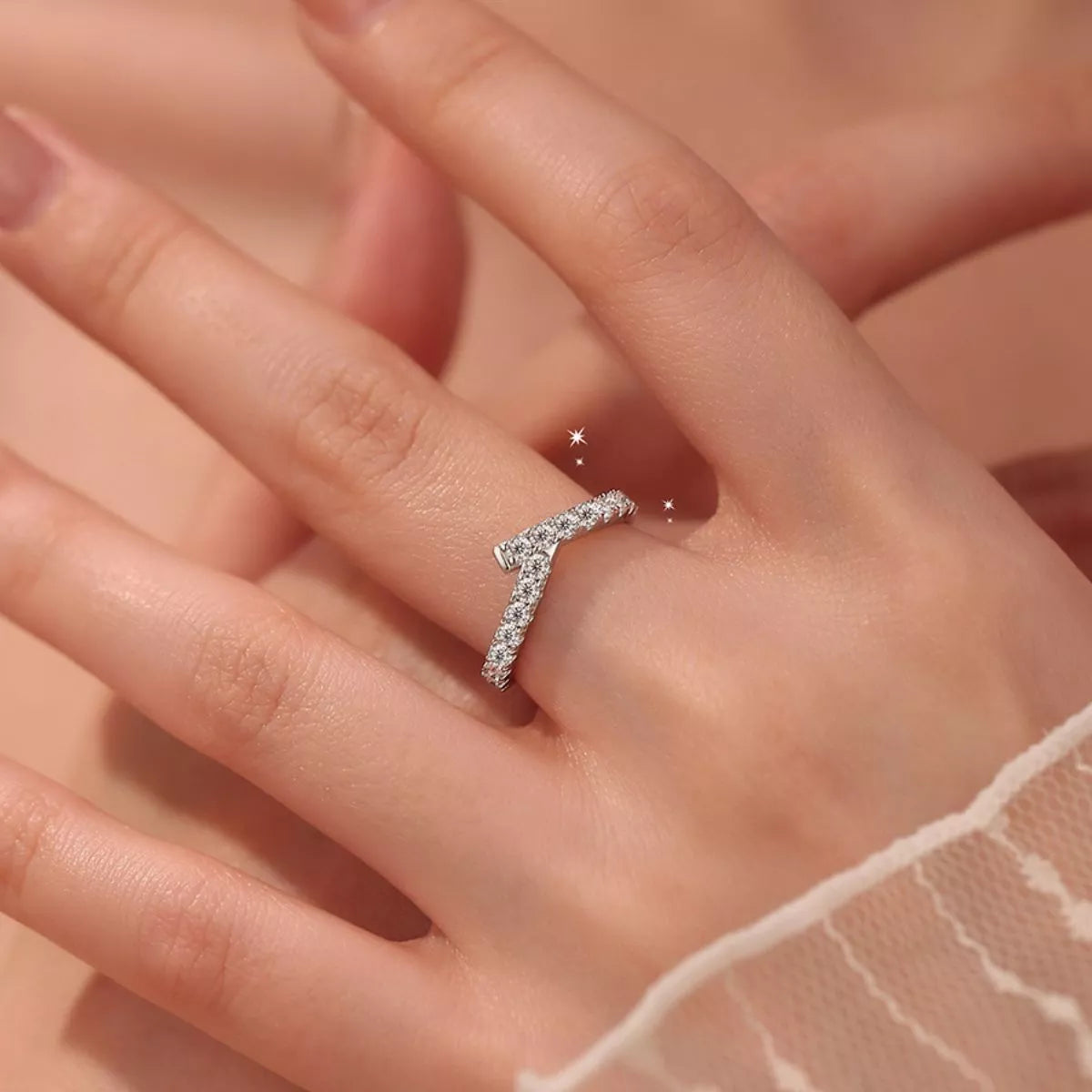 Silver ring on a person's finger with a soft focus background