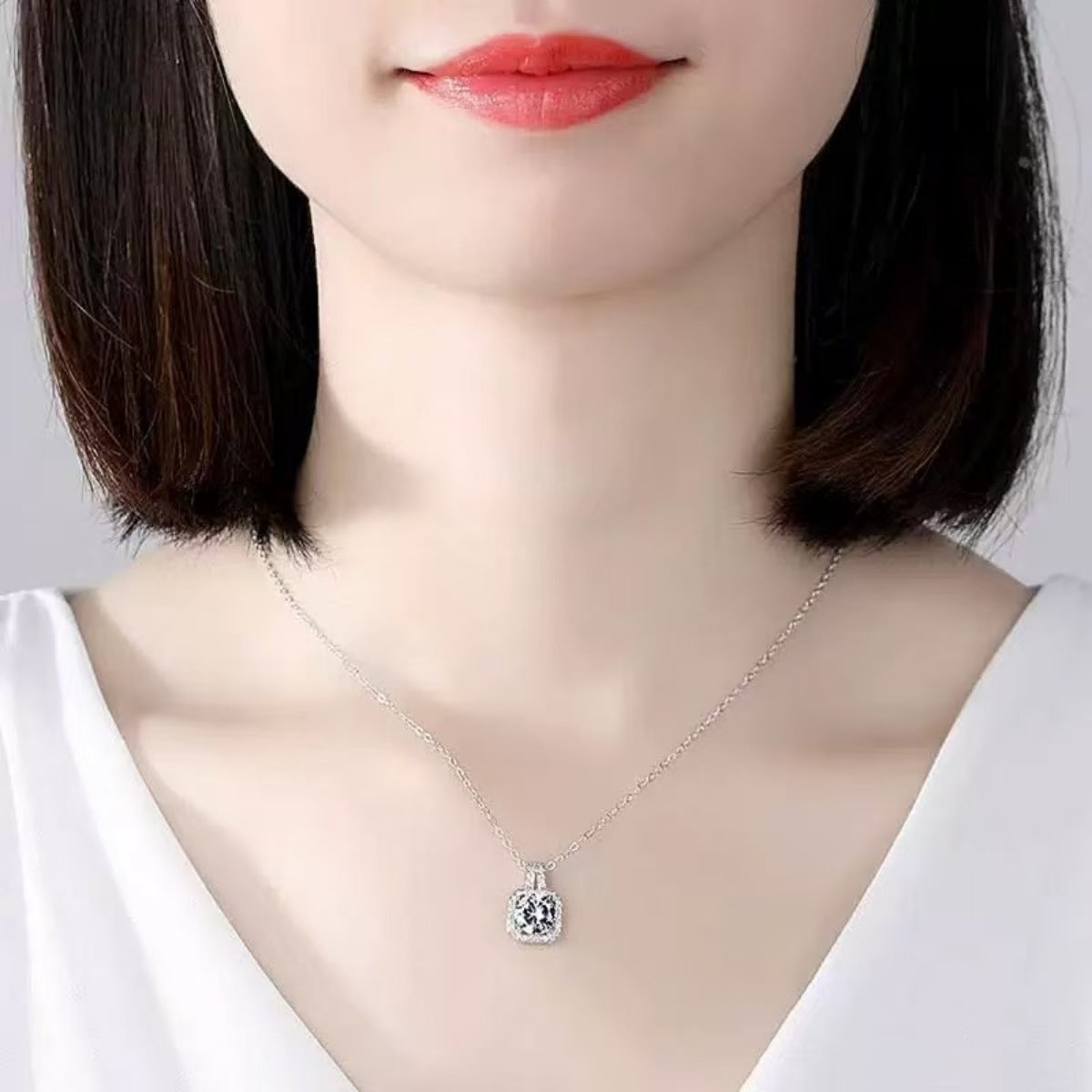 Model wearing Rebellious Gal 1 carat moissanite pendant with rebellious layered look