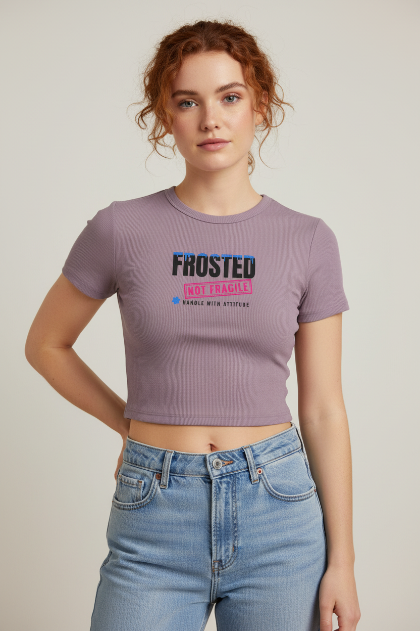Woman with pinned-up auburn curls in the smokey violet Frosted Not Fragile crop tee, pale backdrop
