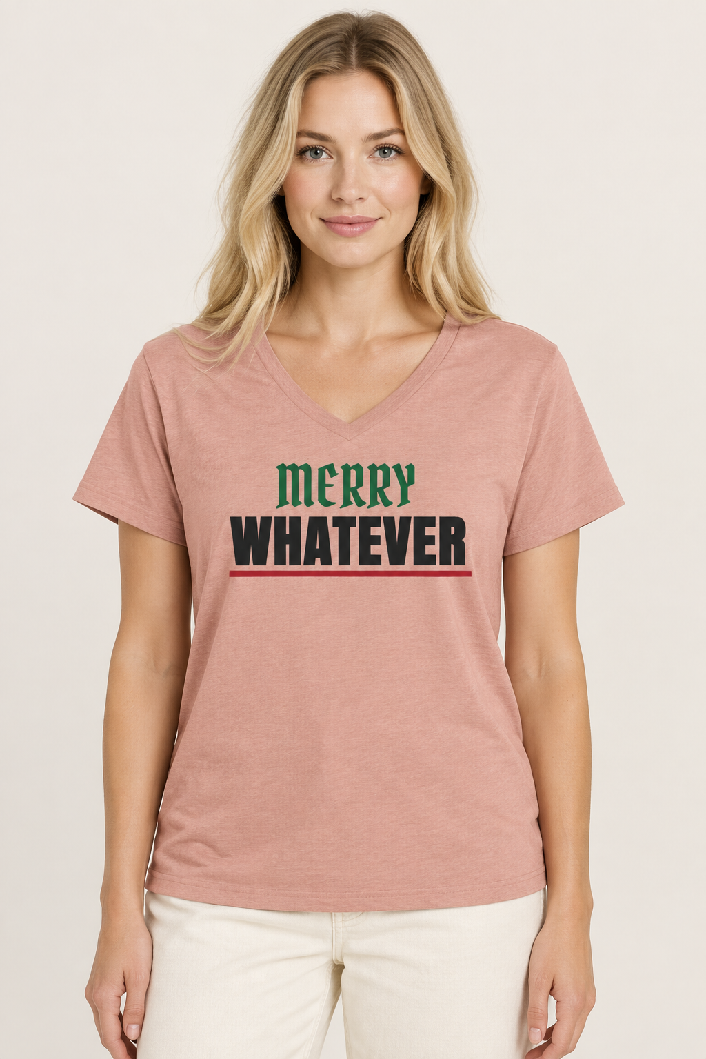 Woman with long blonde hair in the dusty rose Merry Whatever V-neck tee, pale backdrop