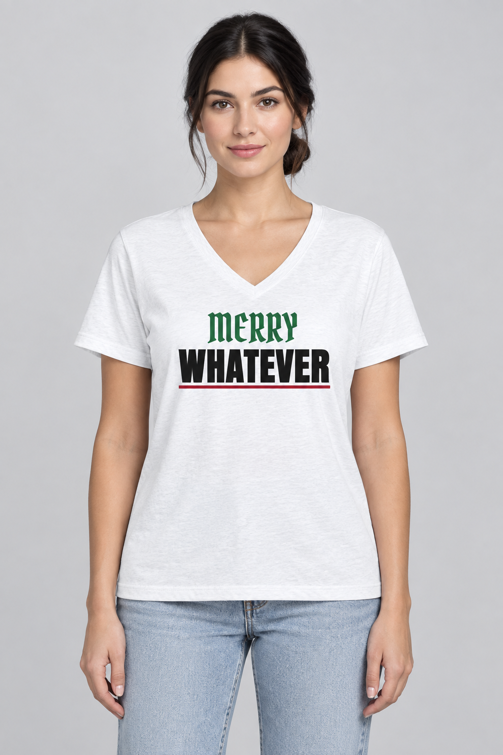 Woman with a dark low bun in the white Merry Whatever V-neck tee, studio backdrop