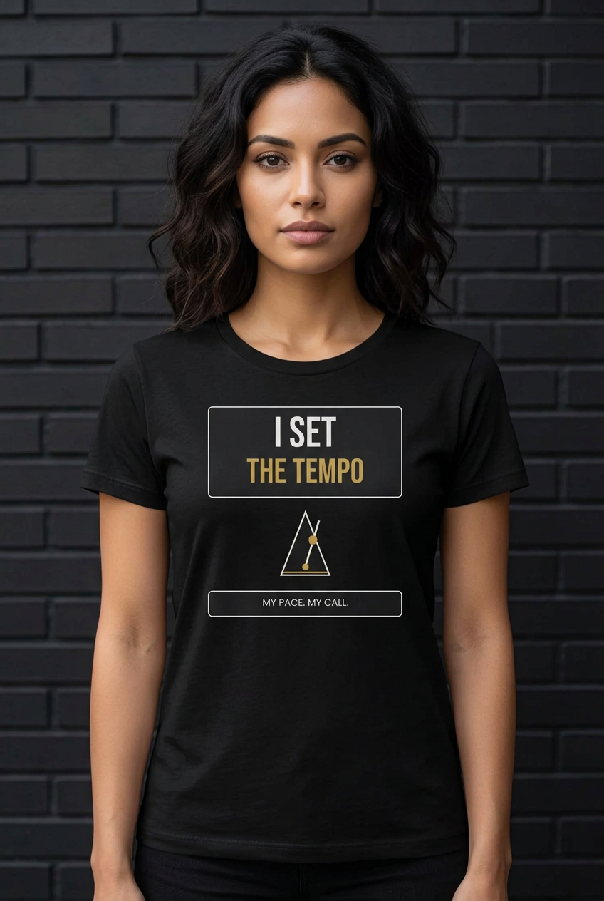 Woman in the black My Tempo crew tee against a dark brick wall