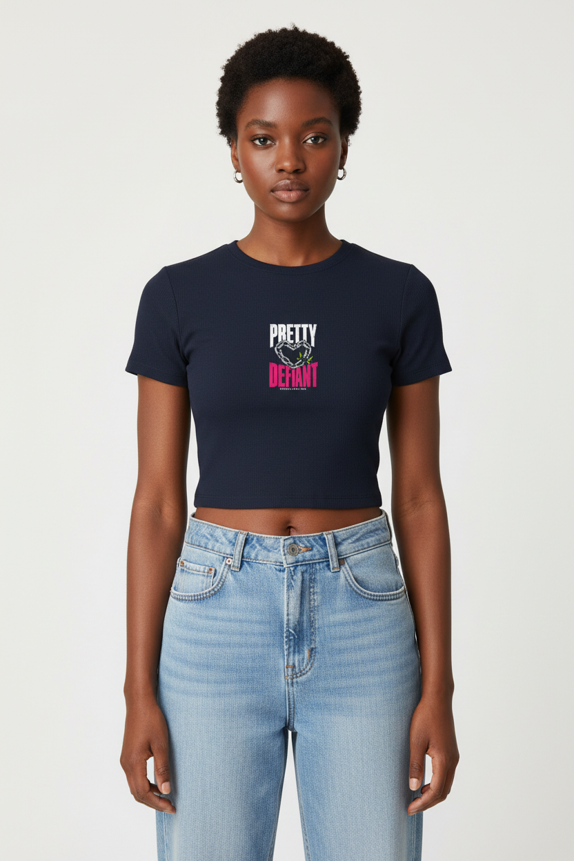 Woman with short natural curls in the navy Pretty Defiant baby rib crop tee and jeans