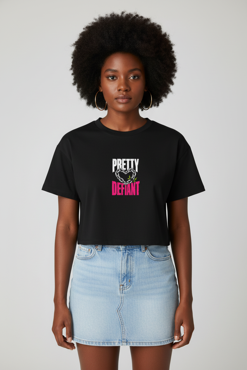 Woman with a natural afro in the black Pretty Defiant boxy crop top and denim skirt