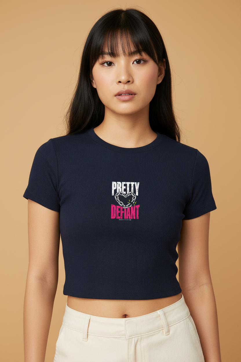 Woman with straight bangs in the navy Pretty Defiant Faded baby rib crop tee, cream trousers