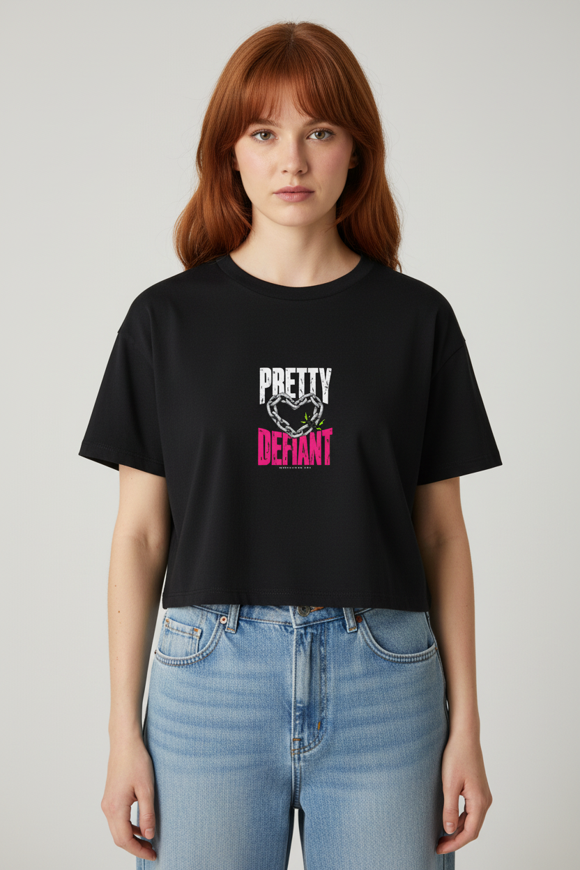 Redhead with curtain bangs in the black Pretty Defiant Faded boxy crop top and jeans