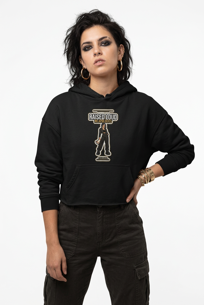 Black cropped hoodie on a plain studio backdrop, gold hoops and smoky eye makeup