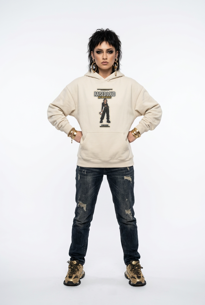 A model stands against a white studio background wearing a beige hoodie with a black graphic print that reads 'FASHION IS A LIE' and 'ROCK N' ROLL', paired with distressed dark blue jeans and brown boots.