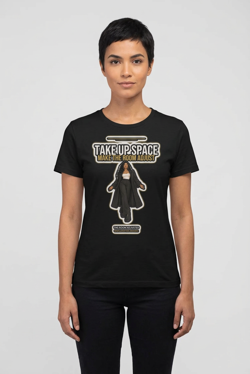 Woman with short dark hair in the black Room Adjuster crew tee, grey studio backdrop