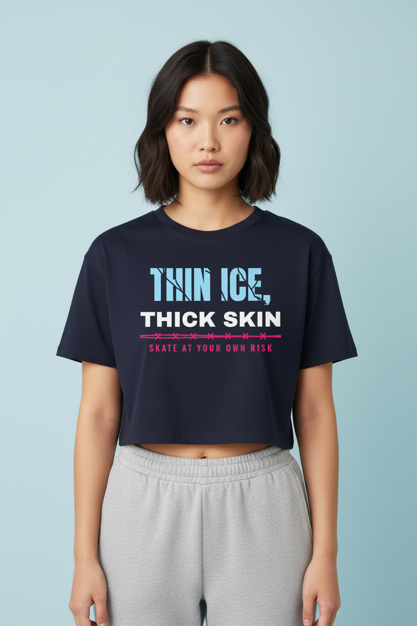 Woman with a layered cut in the navy Thin Ice Thick Skin crop top, blue backdrop