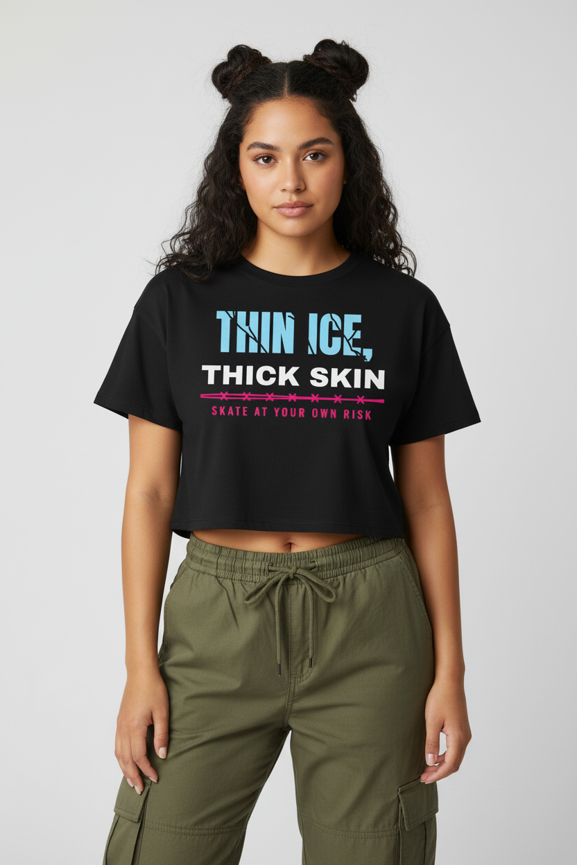 Woman with space buns in the black Thin Ice Thick Skin crop top, studio backdrop