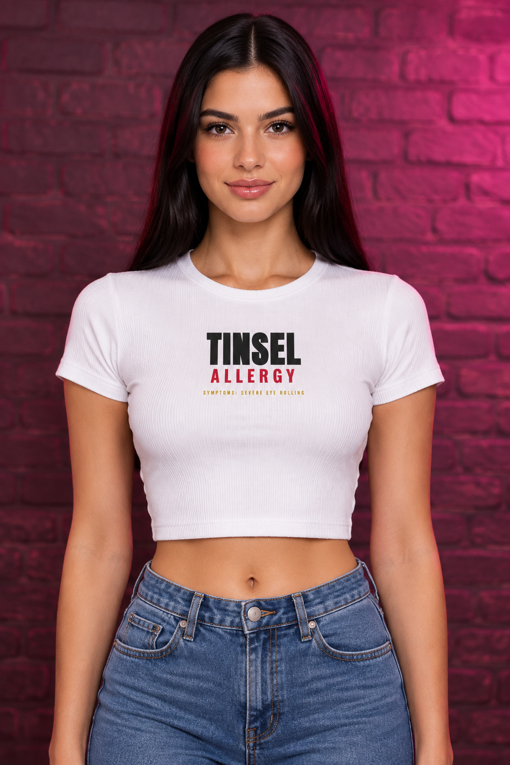 Woman with long black hair in the white Tinsel Allergy crop tee, brick wall